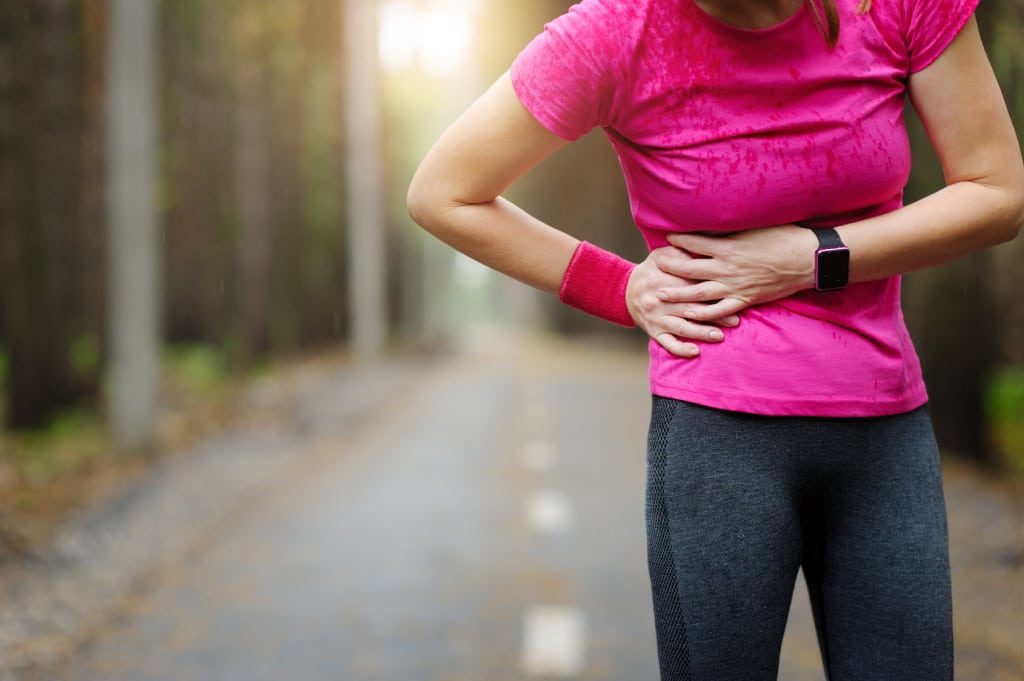 female runner suffering from hip injury