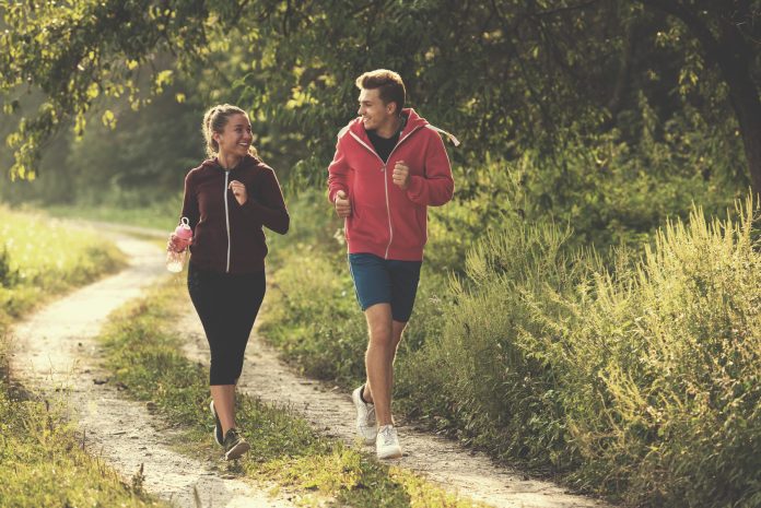 young couple jogging along a country road running with asthma